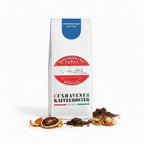 Weiße Kaffeetüte des Cuxhavener Kaffeeroesters mit der Aufschrift Espresso Bugisu und Aromasymbolen vor weißem Hintergrund