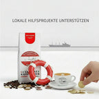 Weiße Kaffeetüte des Cuxhavener Kaffeeroesters mit der Aufschrift SOS Cuxhaven und Symbole zur Aufforderung der Unterstützung von lokalen Hilfsprojekten